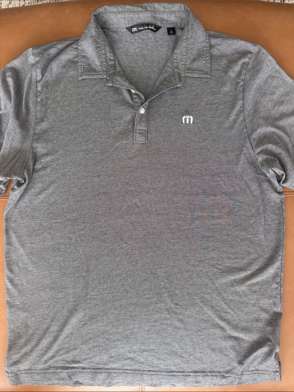 Travis Mathew black and white thin stripe polo
